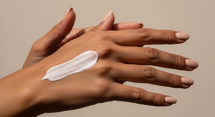 Fototapeta premium Close up of hands applying white cream or lotion for skincare and hydration