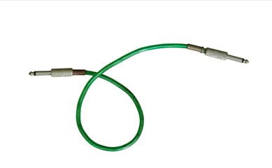 Green audio jack cable with metal connectors for musical instruments and sound equipment isolated on white background