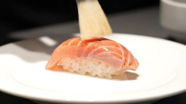 Professional Chef Searing Fresh Salmon Nigiri Sushi with a Kitchen Torch