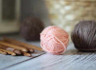 Clews balls of yarn wool and crochet hooks and a basket photo 