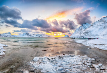 Amazing winter scenery with Haukland beach during sunset and snowy  mountain peaks near Leknes.