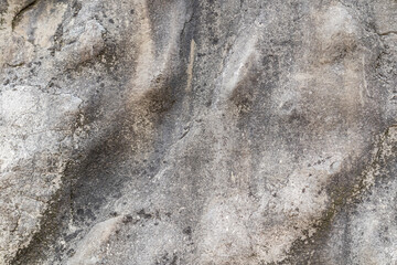 Abstract gray stone wall background. Rocky surface with natural texture. Relief texture of natural rock. Realist photo