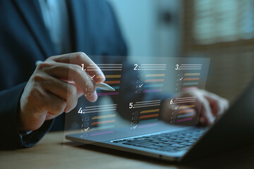 Businessman completing interactive survey or digital assessment on laptop. Smart technology interface for online quizzes, evaluation forms, feedback collection and real-time data analytics.