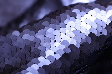 Close-up of matte finish spangle fabric in metallic navy blue tones, showcasing layered sequins with subtle shine and textured surface, ideal for fashion and textile design.