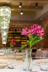 Fresh flowers brighten the dining table, creating a warm and inviting atmosphere for guests