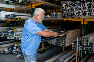 Control of materials for the production of PVC and aluminum profiles. A senior craftsman selects the material for the production of windows and doors.