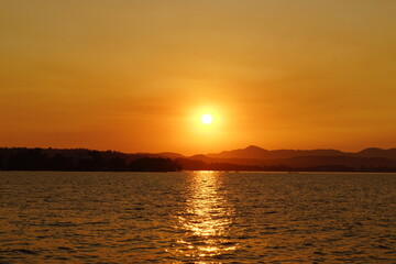 Obraz premium A stunning orange and pink sunset over the Greek Ionian Ocean in the Mediterranean Sea