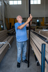 Control of materials for the production of PVC and aluminum profiles. A senior craftsman selects the material for the production of windows and doors.