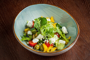 Vibrant salad featuring crisp vegetables, creamy cheese, and fresh greens in a beautiful bowl