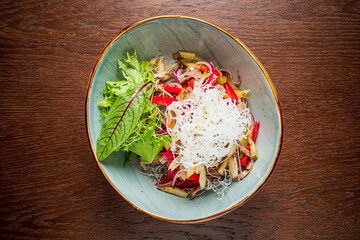 Bright veggies and greens combine artfully in a bowl, showcasing vibrant colors