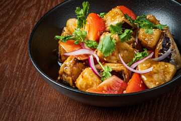 A vibrant mix of vegetables and tender meat covered in golden sauce garnished with herbs