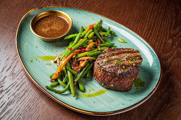 Tender filet mignon with fresh green beans and a rich dipping sauce for a delightful meal