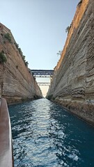 Fototapeta premium Sailing among the giant walls of the Corinth Canal in the Greek Mediterranean Sea
