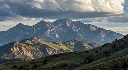 Majestic mountain range under dramatic cloudy sky scenic landscape background