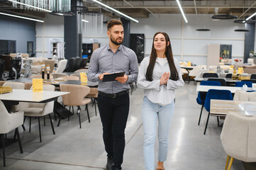 Furniture store customer receiving consultation from salesman