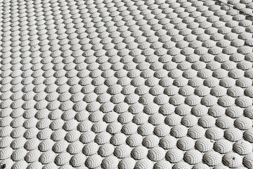 A black and white abstract background with a repeating geometric pattern of spheres covered in a...