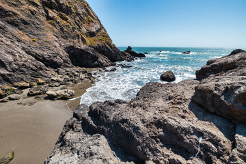 Rocky shoreline at Pirates Cove, reached via Tennessee Valley Trail in Marin Headlands, California. Rugged cliffs, boulders, and the Pacific Ocean waves create a wild coastal scene near San Francisco