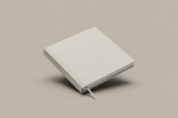 Blank light gray hardcover book with ribbon bookmark angled on neutral background empty notebook