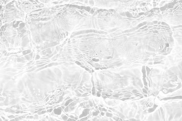 White water with ripples on the surface. Defocus blurred transparent white colored clear calm water surface texture with splashes and bubbles. Water waves with shining pattern texture background.