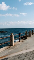 Obraz premium Seaside Promenade with Fence