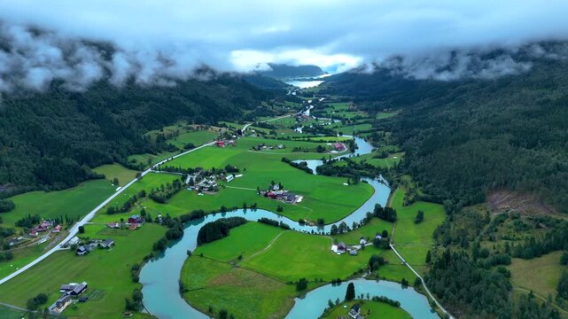 Experience the breathtaking beauty of Stryn, Norway with its vibrant valleys, winding rivers, and idyllic farms. This picturesque landscape captures the essence of Norwegian nature and tranquility.