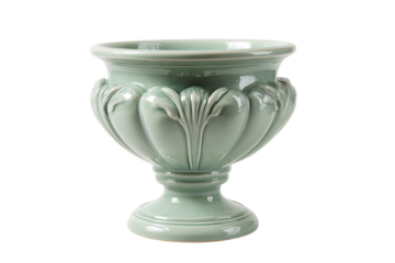 A light green ceramic urn with ornate carvings and a pedestal base, isolated on a transparent background