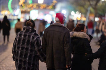 Group of people celebrating christmas at festive market