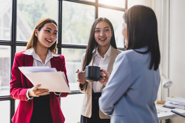 Business meeting, coworkers are discussing in the office. Happy business people discussing during meeting in board room at corporate office. Businesswoman interacting with a colleague.