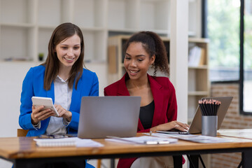 Businesswoman and multi-ethnic colleagues in the workplace are talking and discussing new business projects and collaborations.