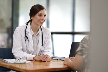 Female doctor comforting patient by holding her hand. Caring doctor holds a patient's hand with empathy and trust in a healthcare setting, showing the importance of human connection.