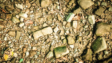 Ground and rocks as natural background. Abstract filter toned.