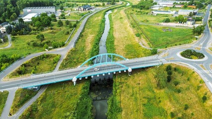 Arched bridge crossing river in summer
