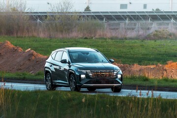 Fototapeta premium Driver in electric car cruising open space