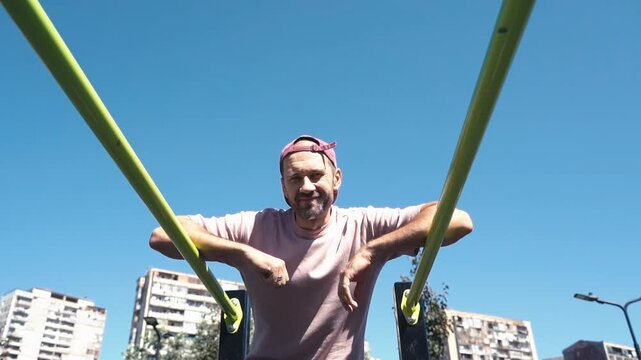 Man Training on Outdoor Bars. Urban Fitness and Street Workout
