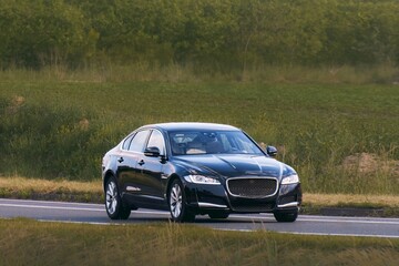 Prestige vehicle speeding on smooth rural road