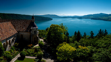 Panoramic view of the lake and garden from above, church with roof tiles