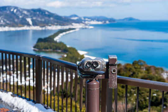 Snowy landscape of the Amanohashidate sandbar, one of the Three Views of Japan, seen from the Hiryukan viewpoint in a winter sunny day. Miyazu, Kyoto, Japan.