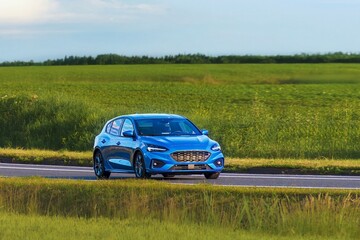Fototapeta premium Modern estate car cruising on scenic highway