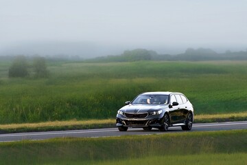 Fototapeta premium Wagon automobile on quiet countryside road
