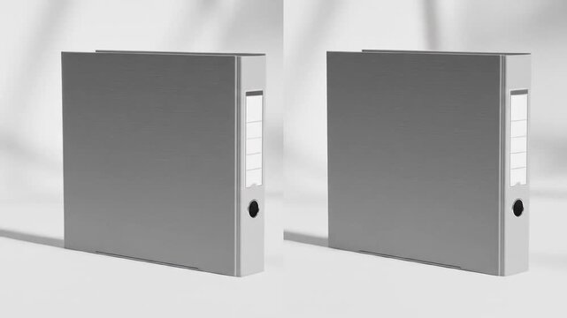 Two blank grey binders standing on a white surface with soft shadows.