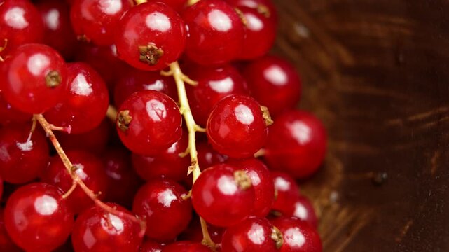 Fresh red currants on stems in a brown kitchen bowl. Organic natural baking ingredient. Top view