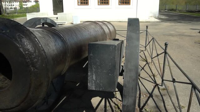 An old cast-iron cannon from the medieval era. The massive historical artillery piece.
