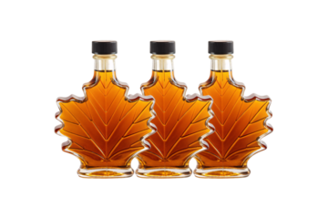 Three glass bottles shaped like maple leaves filled with golden amber maple syrup, isolated on a transparent background