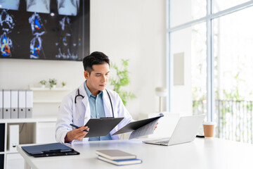 Obraz premium Professional doctor doing paperwork checking medical documents at workplace. Concentrated physician reading medic form analyzing patient diagnosis or report in hospital.