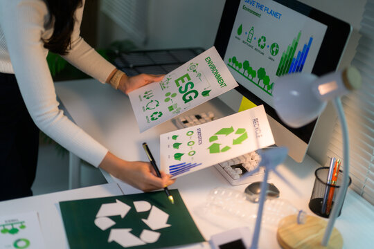 Woman analyzing ESG environment sustainability data and recycling statistics