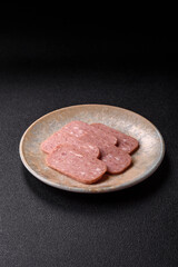 Spiced ham slices, canned meat for lunch sandwiches. Spiced ham as a food background