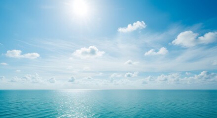 A breathtaking view of a serene blue ocean under a bright, sunlit sky with scattered fluffy clouds, creating a peaceful and expansive natural landscape scene perfect for relaxation