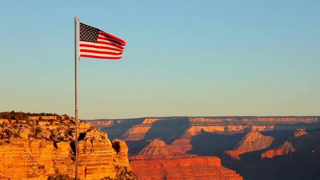US flag Iconic classic shot of Grand Canyon at sunset with amazing lighting, clouds, red cliffs and blue skies in 4K DCI. View of the Grand Canyon