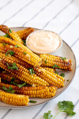 Homemade Spicy Corn Ribs with Mayo on a Plate, side view.