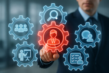 Human resource management and recruitment concept with a businessman touching a central icon of a person surrounded by gears and icons for search, team, training, and communication